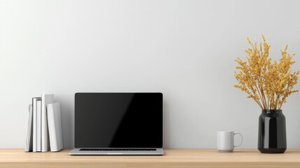 Fototapeta premium Laptop and vase of flowers on a minimal desk with stylish wall poster mockup in a clean office setting