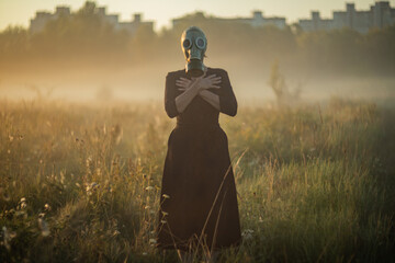 Creepy mysterious character wearing mask and gasmask in fog