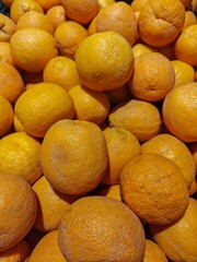Fresh oranges stacked in a grocery store display