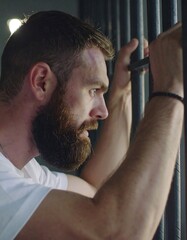 Man behind bars, looking out