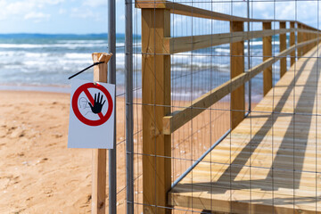 A Beach Pier is currently Under Construction, and Various Water Containers are Present Nearby