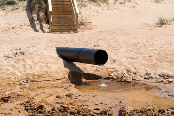 The Pollution Pipe Discharging Waste Water Contaminates the Sandy Beach Area Significantly