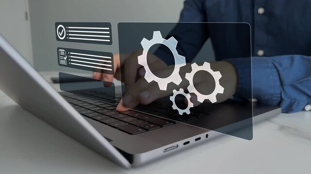 Business process optimisation.Robotic process automation or RPA.
Engineer setting up automated software.Automated industrial technology with digital transformation.