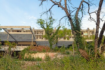 Modernist hotel wings and trees at abandoned Haludovo Palace Krk Croatia