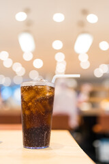 Cold soft drinks with ice cubes on table