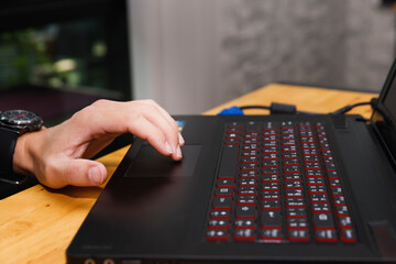 Close up of hand using laptop touchpad for navigation and work, technology and digital lifestyle...