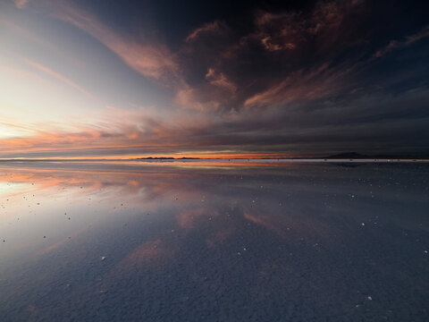 Mirror reflection landscape of salt plant in Bolivia at sunset