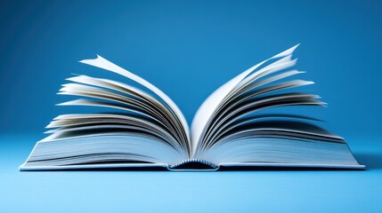 Open book, pages fanned, light blue background