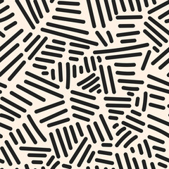 Black lines scatter on beige in a dynamic abstract repeat, ideal for wallpaper or textiles
