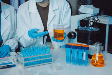 Fototapeta premium Collaboration, tablet or science with people in lab together for research or development. Innovation, tech and microscope with scientist team in clinical trial for planning or medical investigation
