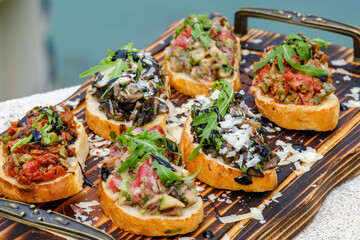 Delicious Assorted Bruschetta on Wooden Board with Fresh Toppings