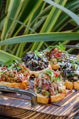 Delicious Assorted Bruschetta on Wooden Board with Fresh Toppings