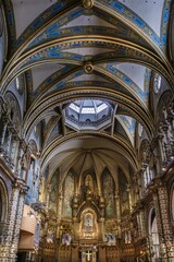 Interior of Montserrat Monastery Basilica, Catalonia, Spain. Ornate Religious Architecture, Grand Vaulted Ceilings, Blue and Gold Decorations, Sacred