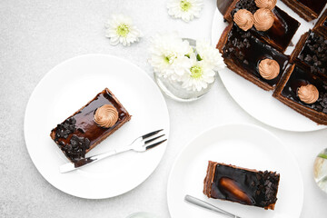 Decadent chocolate cake slice with cream swirl and dark fruit topping on white plate with fork