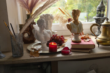 vintage interior, candles, books, windowsill with antiques