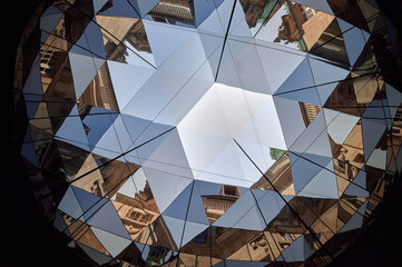 A creative abstract reflection of Hamburg’s architectural elements through mirrored surfaces, creating a kaleidoscopic effect of geometric shapes and vibrant colors.