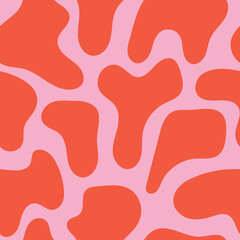 Seamless pattern with cow spots in a fun, trendy pink and orange color palette