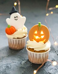 Halloween cupcakes decorated with ghost and pumpkin