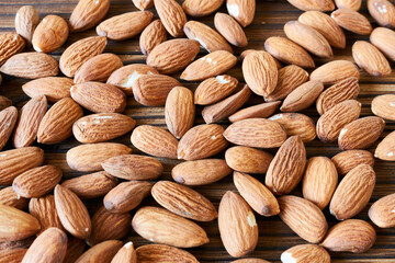 Almond nuts on wooden background. Close-up. Top view.
