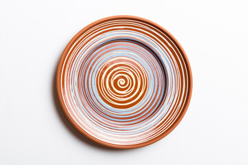 Top view of isolated of colored background empty round brown plate for food. Empty dish with space for your design
