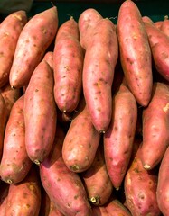 Pile of vibrant pink sweet potatoes