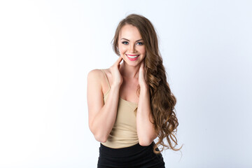 Portrait of beautiful young woman with healthy teeth and long hair look at camera over white