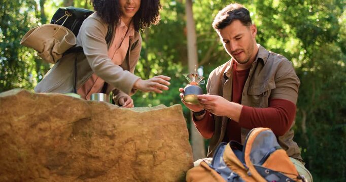 Couple, kettle and backpack with hiking in forest with helping hand, bonding or vacation in summer. People, man and woman with gear, travel and packing with interracial love for adventure in woods