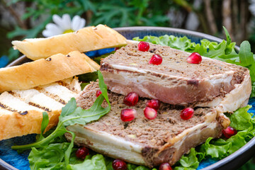 A delectable display of gourmet pate served on lettuce leaves, accompanied by slices of fresh...