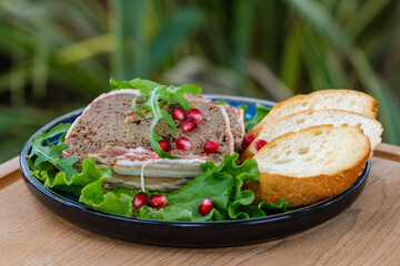 A delectable display of gourmet pate served on lettuce leaves, accompanied by slices of fresh...