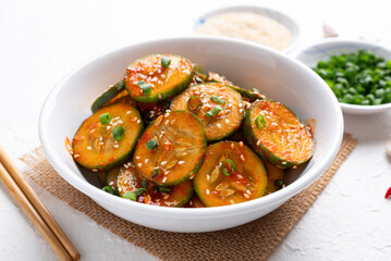 Korean cucumber salad (Oi muchim) in bowl on white background, Korean side dish