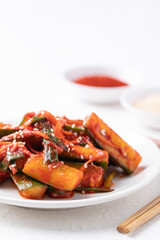 Korean kimchi cucumber on white plate, Korean side dish, Homemade food