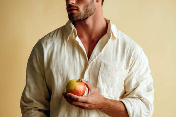Minimal studio portrait of young farmer with apple – modern agriculture visuals for sustainable food, health and farming-related topics