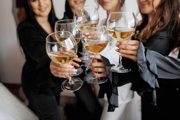 Women celebrating with glasses of champagne at a joyful gathering in a cozy interior