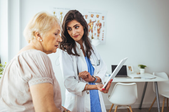 Female Doctor Discussing Health Results With Elderly Woman in a Clinic Setting