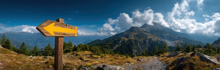 Fototapeta premium Mountain vista with wooden directional sign