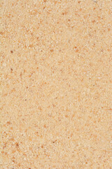 An overhead, detailed macro shot of a texture made of small, irregularly shaped pieces of breadcrumbs