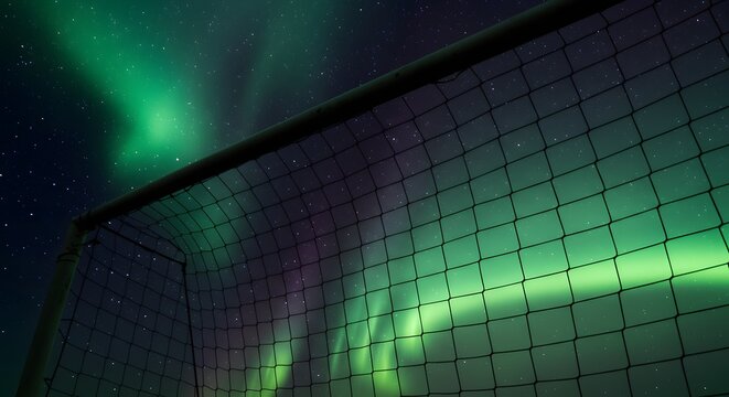 Football net silhouette filled with aurora borealis night sky - Powered by Adobe
