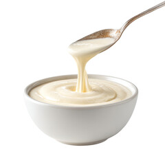 Creamy, off-white sauce pouring from a spoon into a shallow bowl