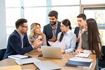 Business team in focused discussion about company growth and performance during meeting
