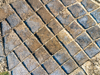 Aerial view of a textured stone pathway with earth tones and geometric patterns under the Maltese sun, Gozo, Gozo, Malta.