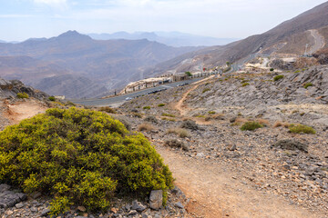 Most visited spot Jebel Jais scenic mountain landscape at Ras Al Khaimah, UAE. Breathtaking rocky peaks, winding roads, and popular tourist destination for hiking, camping, and zipline adventures