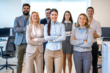 Business team arranged in triangular formation with women in front demonstrating confidence