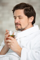 happy man enjoying smelling delicious hot tea