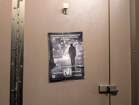 Canada, 31 July 2025 : Support poster for addiction help inside a public bathroom stall