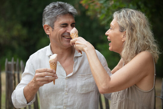 portrait of an happy mature couple eating an ice cream