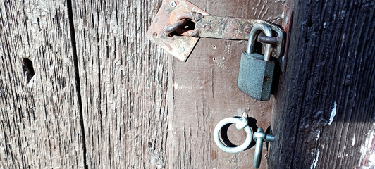 Antique handle of a solid wood door in Tuscan style.
