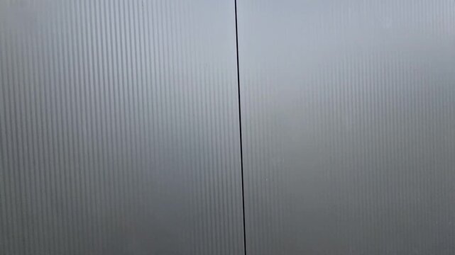 sandwich polyurethane vapor barrier building panels. structure is made of steel from assembled beams and a shell with a metal surface. hall. stable, warehouse haylofts, door, light above