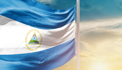 Nicaragua national flag waving in an amazing sunlight. National flag waving on mast.