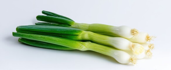Fototapeta premium The Scallions Lying on a Clean White Surface Ready for Cooking and Garnish