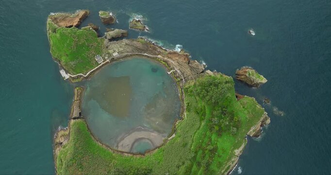 Aerial view of the Islet of Vila Franca do Campo, a volcanic crater with lush green vegetation and a tranquil inner lake, Vila Franca do Campo, Azores, Portugal.